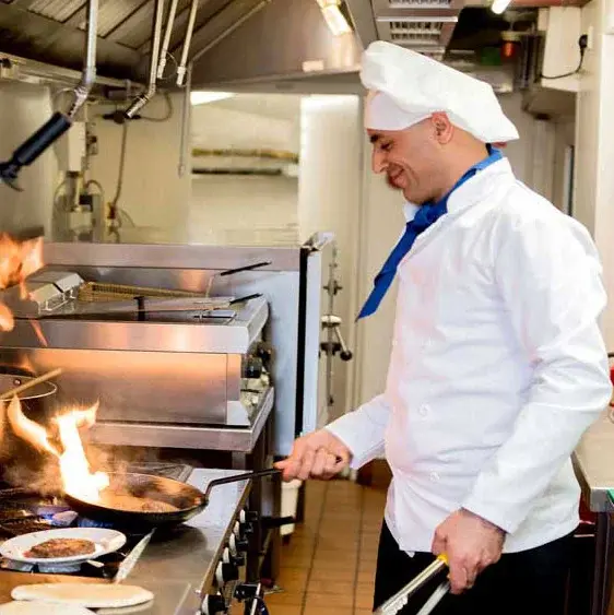 Salishan Chef Created Meals, chef frying a dish.